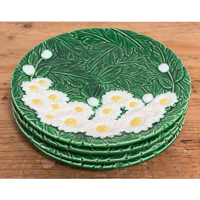 Charming vintage dessert plate set featuring white daisy pattern with vibrant green leaf background. Four plates measuring...