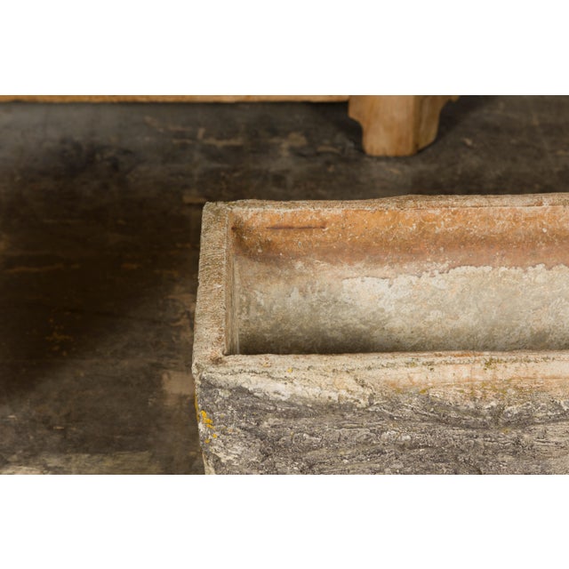 A pair of faux-bois trough shaped planters from the Midcentury period, made of concrete and accented with grey and orange...