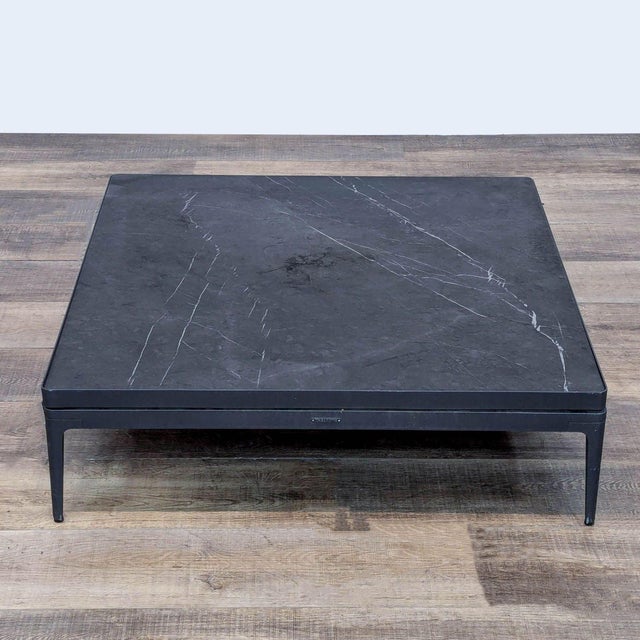 The Grid outdoor coffee table features an aluminum powder coated frame with a Nero Ceramic top in Meteor. Brand: Gloster....