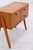 A beautiful vintage bedside table from the 60s with a clean, compact design and a calm, even grain. The drop-down door...
