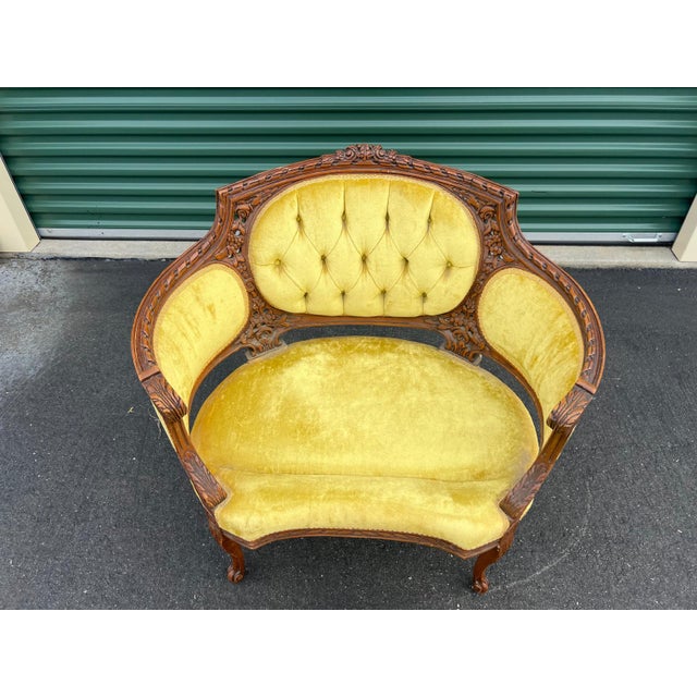 A beautifully detailed Victorian parlor chair crafted circa 1880s–1890s in the Victorian style, featuring richly carved...