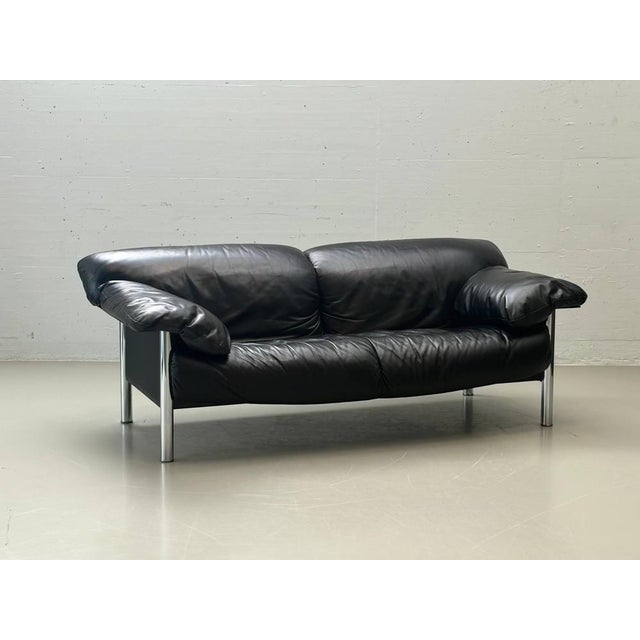 Elegant three-seater sofa, model *pause*, designed by pierluigi cerri for poltrona frau in the 1990s. The design combines...