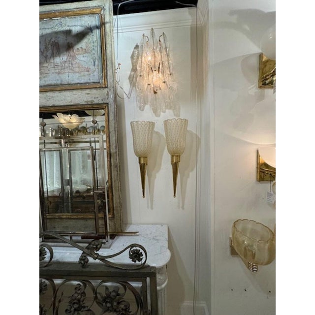 Lovely pair of modern cone form brass and Murano glass sconces. Pretty glass with translucent glass and with gold polka...