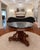 An elegant antique center table featuring a substantial octagonal black marble top resting upon an exceptionally well-...