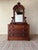 This antique wooden dresser features an impressive arched mirror, sculpted drawer pulls, three generous drawers, and a...