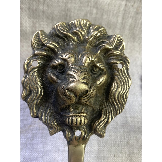 Pair of lion head-shaped coat hooks in solid brass. English production, 1940/50, cast in high-quality solid brass, a...
