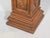 A carved wooden pedestal cabinet in a rich walnut finish with an inset marble top, gadrooned molding, single door, finely...