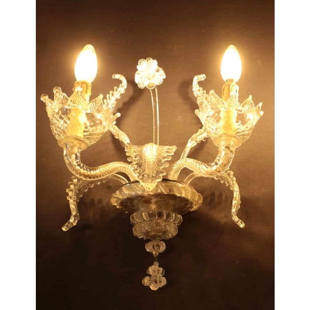 Glass wall lamps made of venetian glass. Blown and hand-cut glass. The lamps are restored with new wiring. Each lamp is...