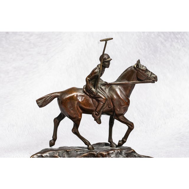 A distinguished solid bronze catchall sculpture depicting a poised polo player on horseback, attributed to renowned...