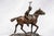 A distinguished solid bronze catchall sculpture depicting a poised polo player on horseback, attributed to renowned...
