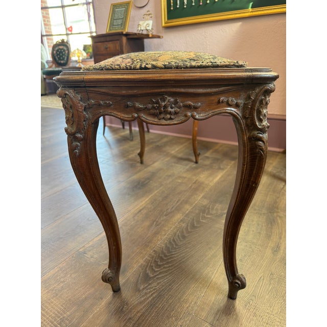 French Provincial Piano Bench reminiscent of Louis XV style. Featuring a needlepoint upholstered seat in a whimsical...