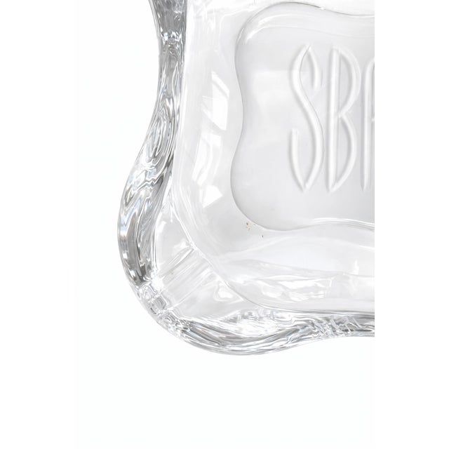 This substantial, heavy glass ashtray features a beautifully sculptural, softly contoured form and a deeply engraved...