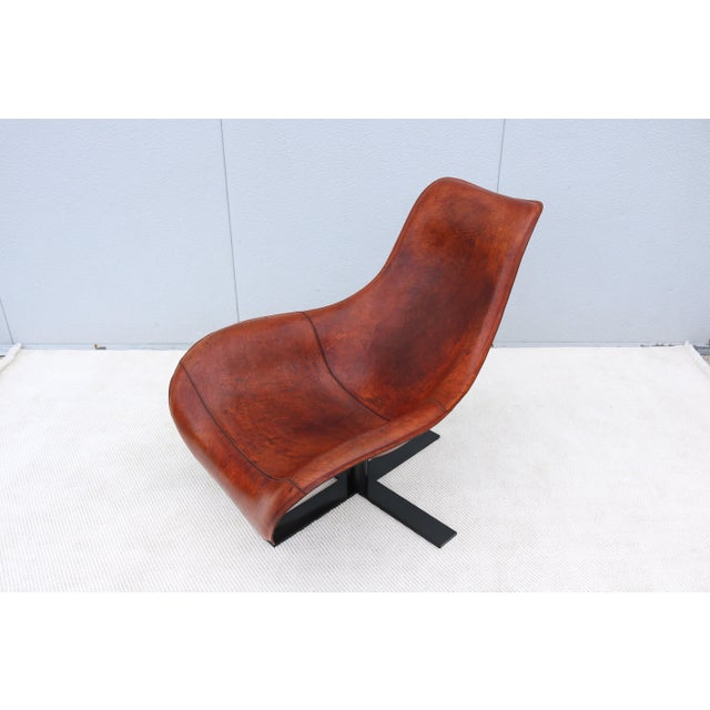 Stunning Mart swivel lounge armchair in patinated cognac brown leather, designed by acclaimed designer Antonio Citterio in...
