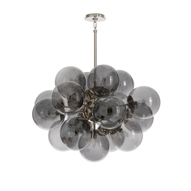 The Shine Chandelier is a beacon of joy, evoking the whimsy of a cluster of balloons with a nod to mid-century modern...