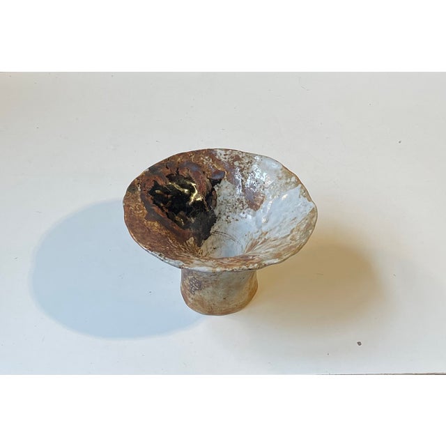 A unique chanterelle shaped pottery vase/bowl in earthy polychrome glazes by the danish female ceramist Conny Walther....