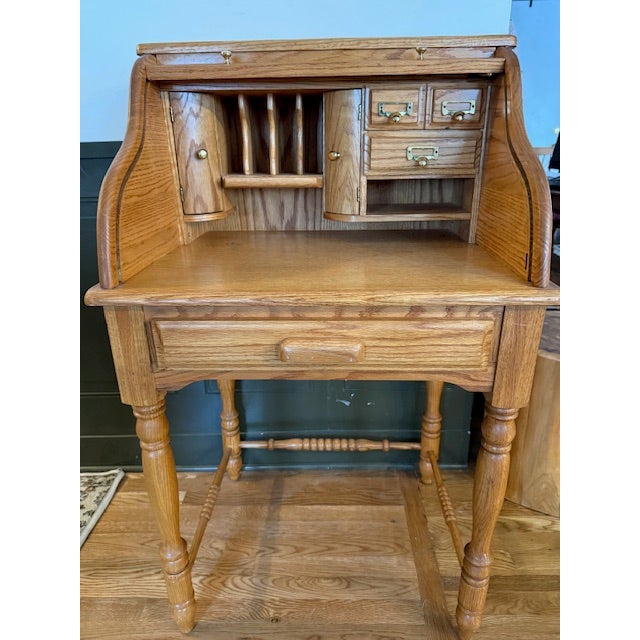 Oak rolltop secretary desk. Judging by the stain color I'd say that it would have been a perfect fit in someone's home in...