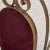 A pair of vintage sculptural side chairs featuring intricate gilded iron frames with high backs and elegant scroll motifs....