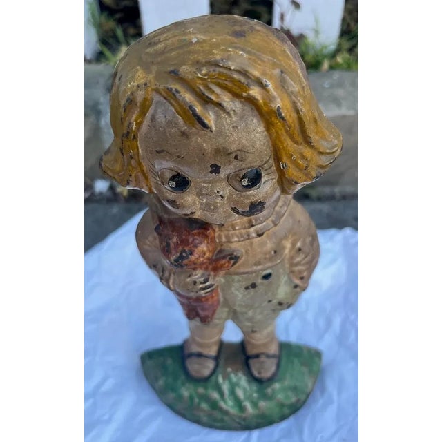 This fun and folky Kewpie girl cast iron doorstop is quite rare and in original painted surface.Notice she is holding a...