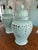 An impressive pair of large Chinese-style celadon porcelain covered jars, each measuring H 23.5'' x W 12'' x D12'' The...