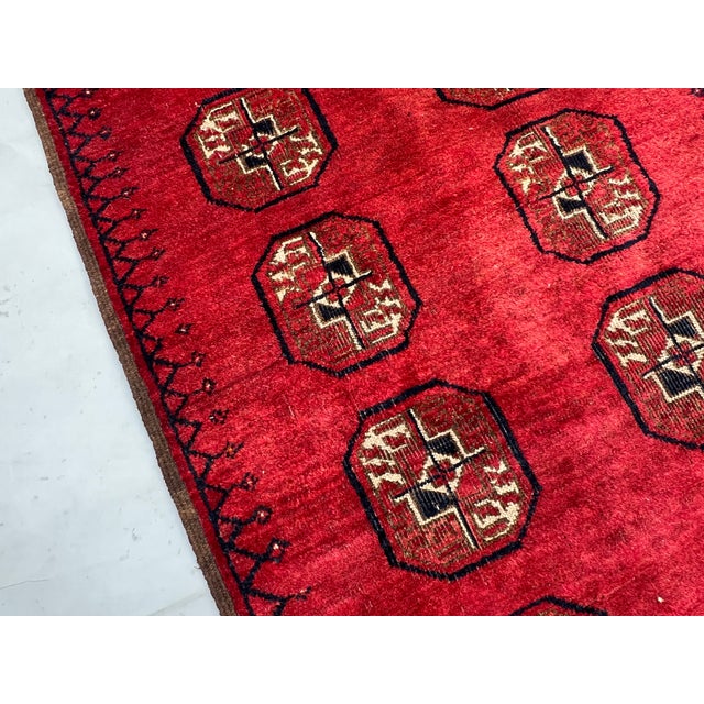 A bold vintage Afghan Khal Mohammad Bokhara runner featuring two columns of classic Tekke guls — the iconic octagonal...