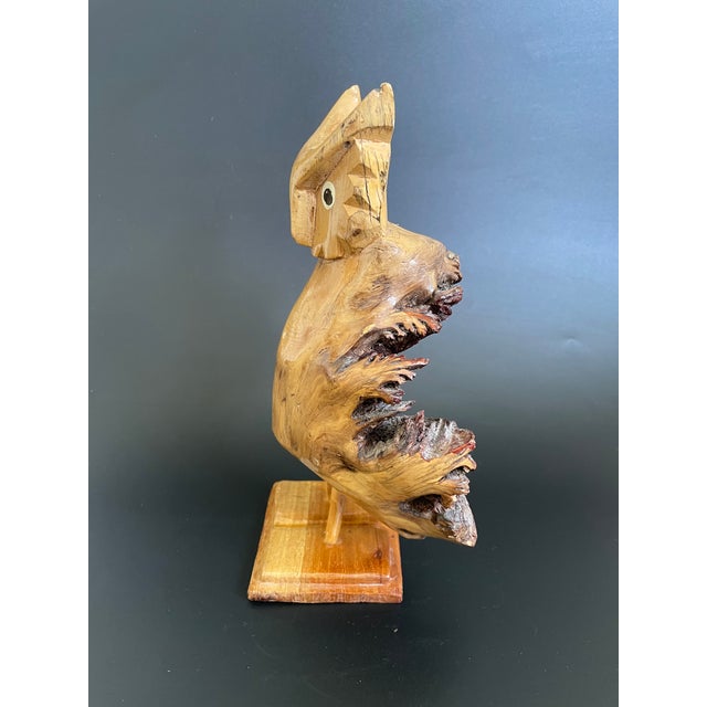 This charming owl sculpture is hand-carved from parasite wood and lacquered for a glossy finish. The parasite wood is a...