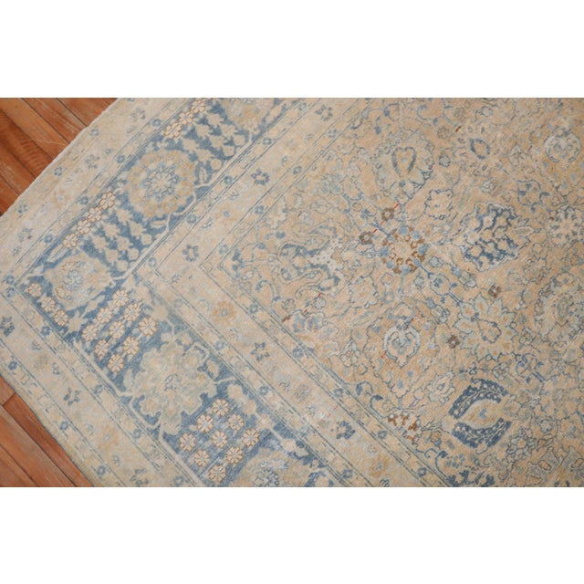 1920s large room size Persian Tabriz rug with an all-over design with light blue and cream accents on a butter color...