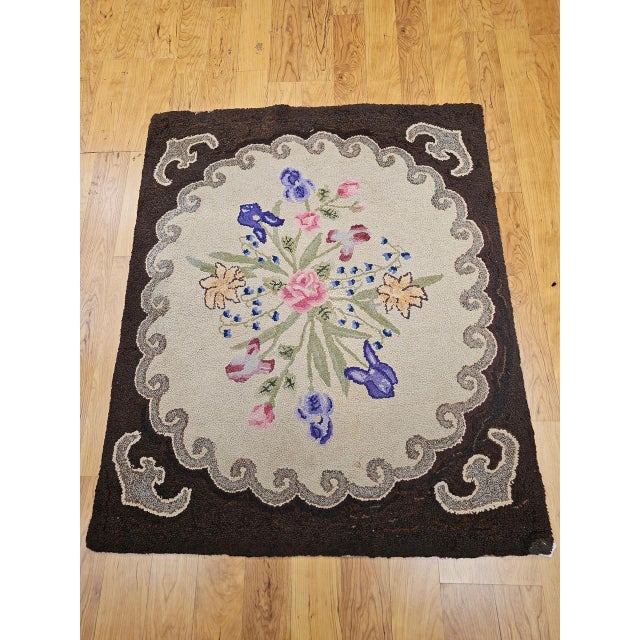 This exceptional Vintage American hand-hooked rug, dating to the early 1900s, is a rare and beautifully preserved example...