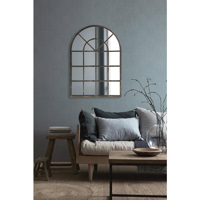 The Fenetre Mirror resembles a beautifully arched paneled window. The metal frame is finished in a lovely oil rubbed...