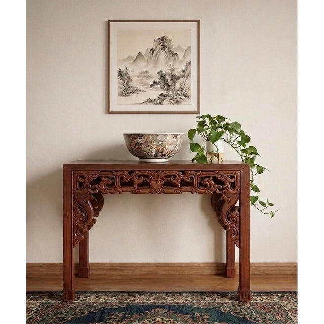 An exquisite 19th-century Chinese console table featuring exceptionally detailed, hand-carved openwork aprons and...