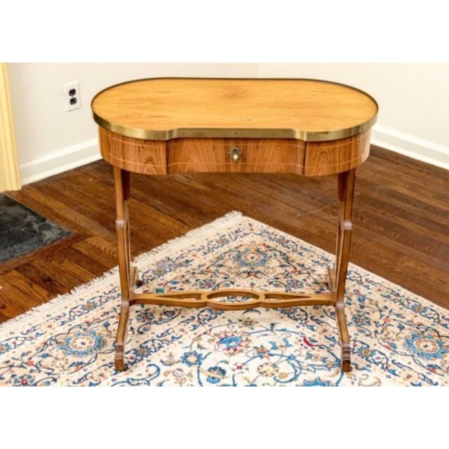 Mid-Century Baker Furniture Regency Rosewood Kidney Desk with Solid Brass Gallery Banding Elevate your interior with the...