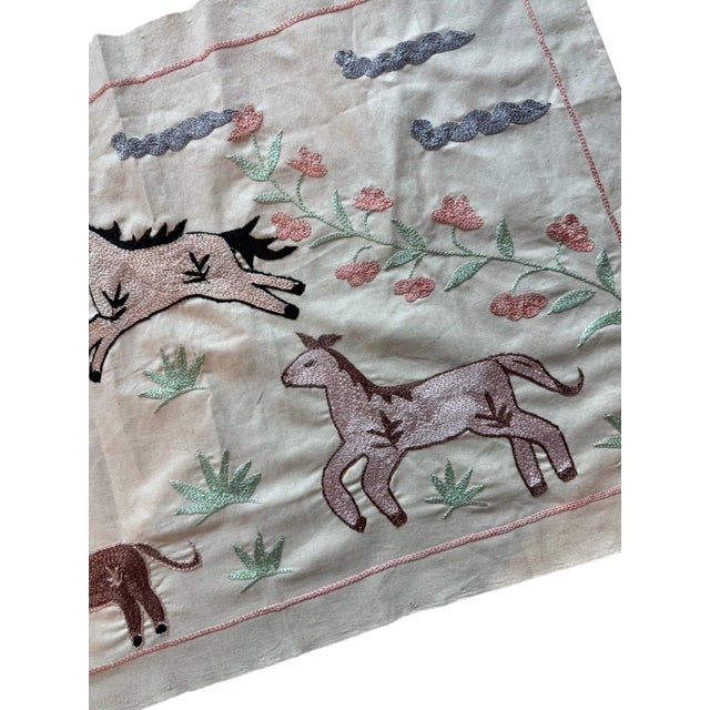 Hand-embroidered Suzani panel from Uzbekistan, worked in fine floss on a cream cotton ground. Six horses move across the...