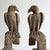PAIR OF BIRD OF PREY CARVINGS Depicting a pair of birds of prey, believed to be falcons. Carved in a stylised naive folky...