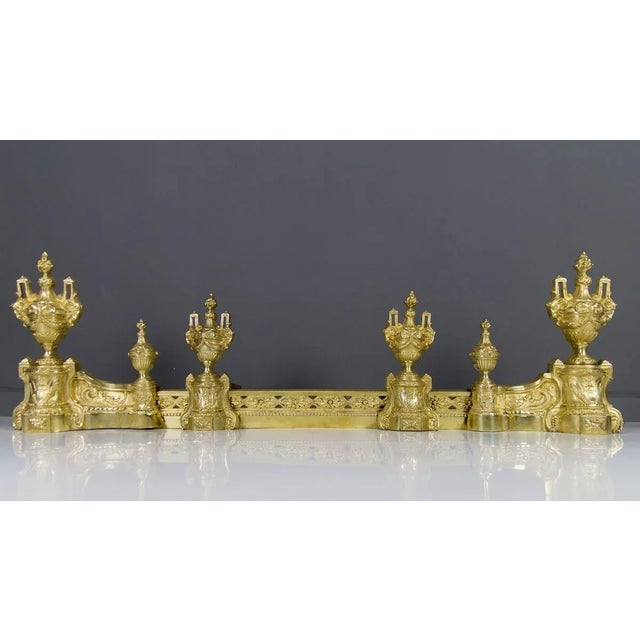 These impressive french louis xvi style bronze andirons with their original fender date to the second half of the 1800s...