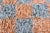 Terracotta orange and Slate Blue Checkerboard Beni Mini Rug. All of the incredible hand-knotted craftsmanship of our...