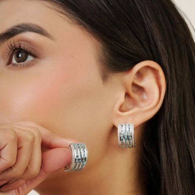 A refined expression of elegance, these 925 sterling silver earrings feature square-cut blue topaz gemstones totaling 4.71...