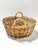 This vintage handwoven wicker basket features a classic round form with finely woven willow and beautifully wrapped loop...