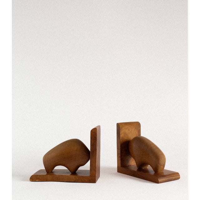 Carved from solid walnut, this pair of bookends balances geometric structure with softly organic form. Rounded, abstract...