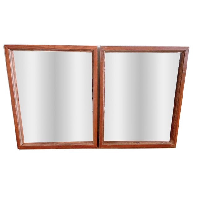 A pair of bathroom vanity mirrors with frames handmade from reclaimed wood.