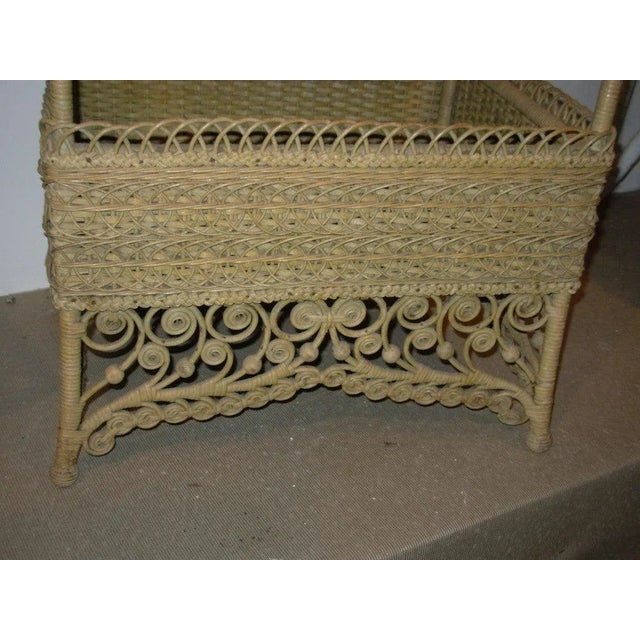 A natural wicker sewing basket, in an elaborate design, original and never painted.