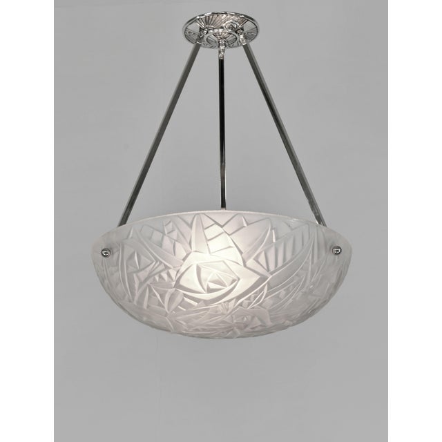 NOVERDY A French 1930s art deco pendant light in nickel plated solid brass holding a bowl in clear frosted molded-pressed...