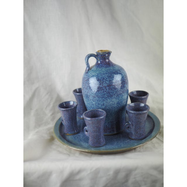 Late 20th French Cottage Blue Ceramic Liquor Set - One Decanter, Six Goblets, One Plate This delicate set mix a french...