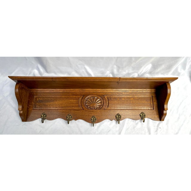 French carved tiger oak wall shelf. Originally created to hang coats in an entry with a wall shelf for hats. Now it makes...