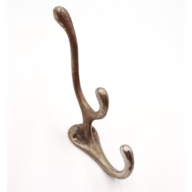 Vintage wall hook made of brushed steel with three stacked arms. The original mounting screws are not available. Good...