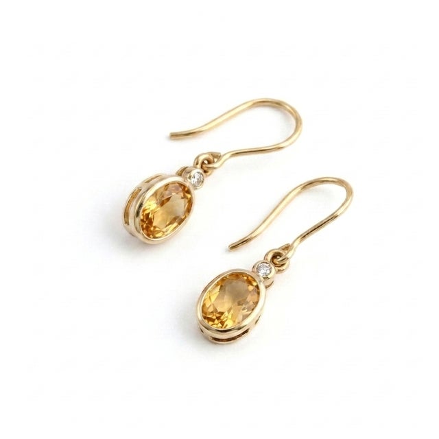 Add a touch of timeless elegance to your jewelry collection with these beautifully crafted Oval Citrine Drop Earrings....