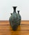 A handsome set of three vintage bronze decorative vases featuring elegant bottle-form silhouettes with naturally tapered...