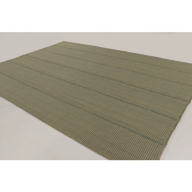 Handwoven in wool, this 10x14 contemporary kilim is a sophisticated addition to Rug & Kilim’s curation. This Indian piece...