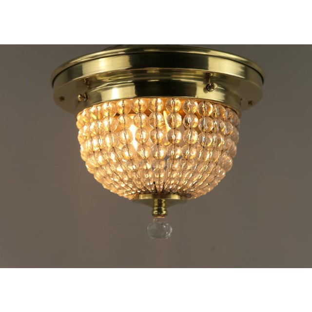 Massive brass holder with faceted crystal glass beads The brass surface is polished. Diameter: 21 cm, height: 16 cm 1 x...