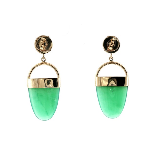 A late 20th-century 14k yellow gold drop earring featuring green chrysoprase stones. The top holds and bezel set moonstone...