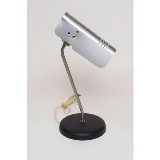 Vintage Modernist table lamp supported by steel stem and black painted metal base by Targetti Sankey (ca. 1970s, Italy)....