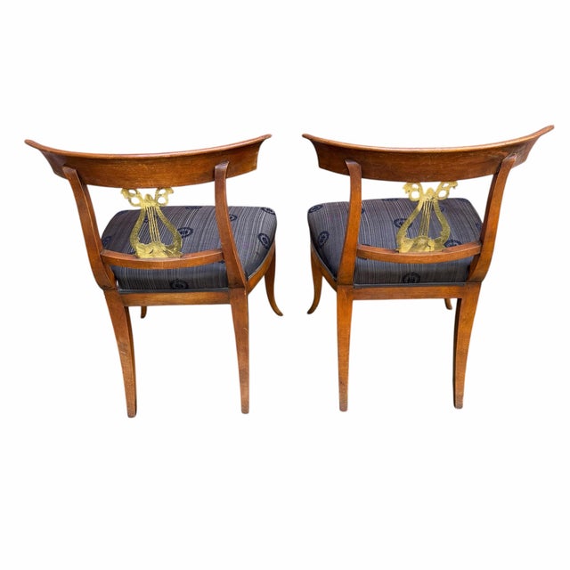 Set of traditional lyre back dining chair with brass lyre accent. These chairs have some minor scuffs and chips along with...